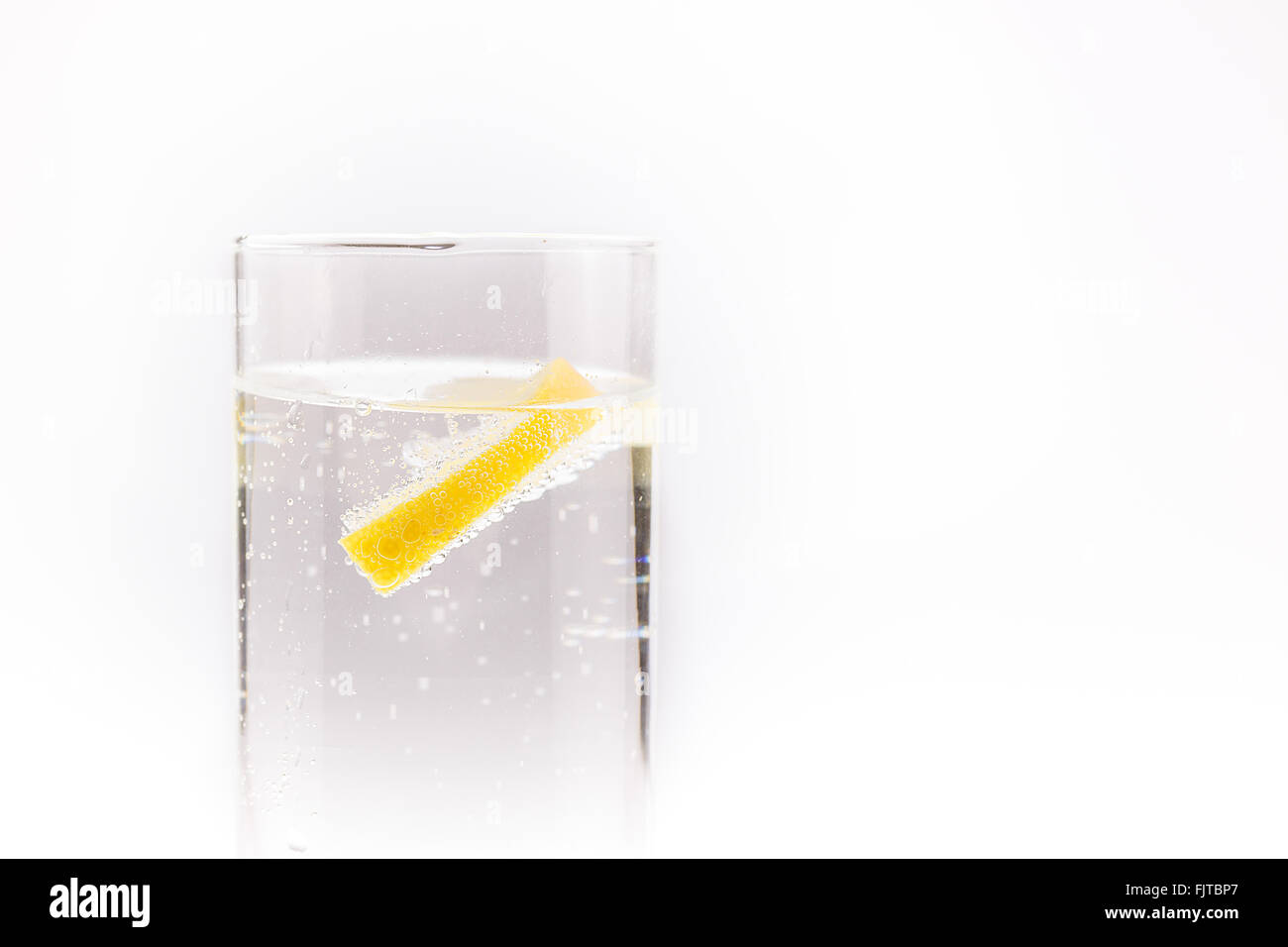 soda water with a slice of lemon floating in Stock Photo