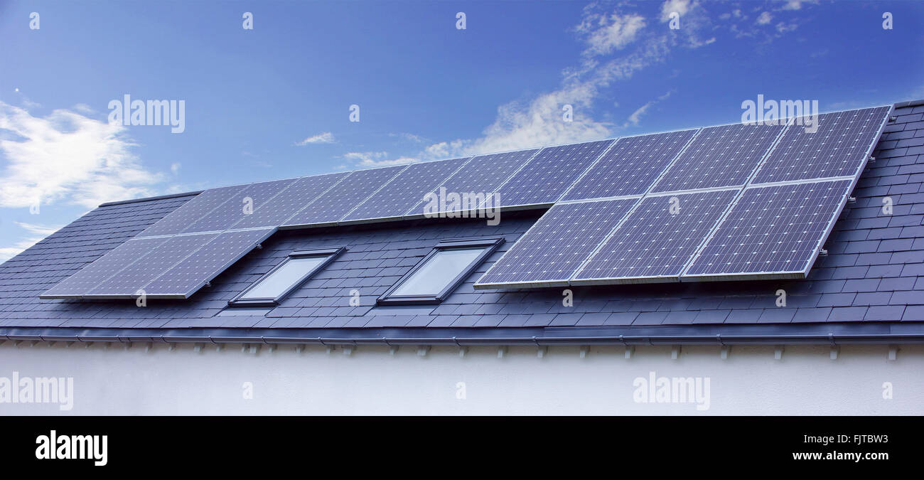 Solar Panels On House Roof. Sustainable Renewable Energy Stock Photo