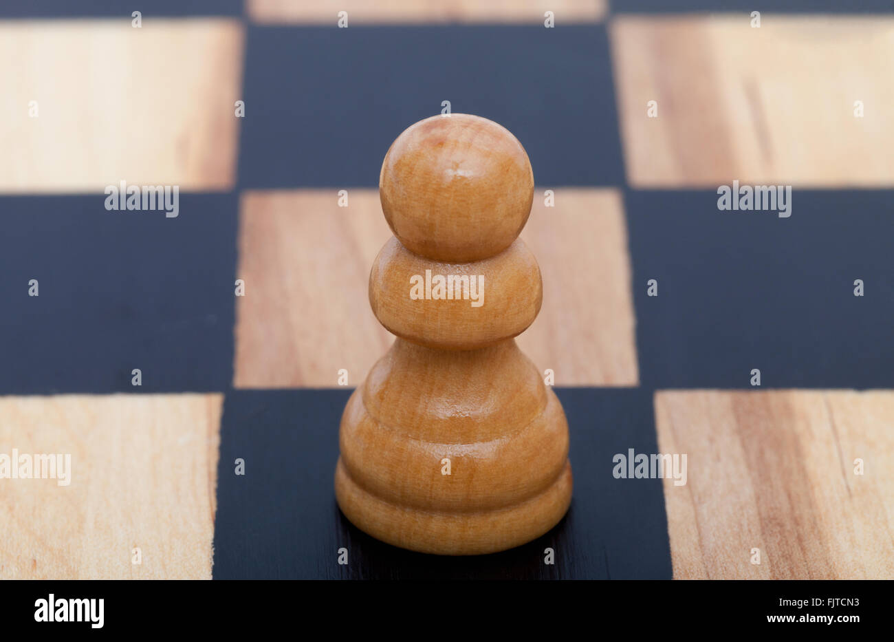 A single pawn on a chess board Stock Photo