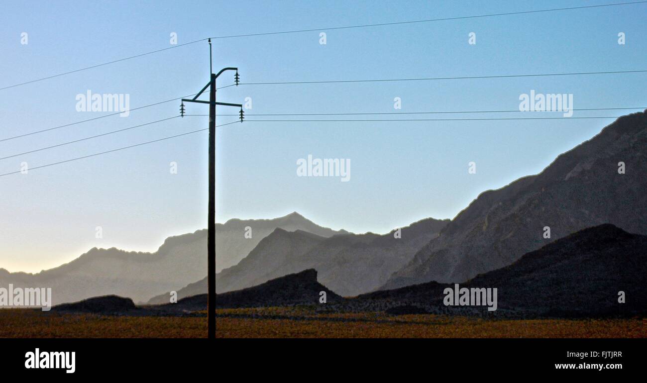 Pole Against Mountain Range Stock Photo