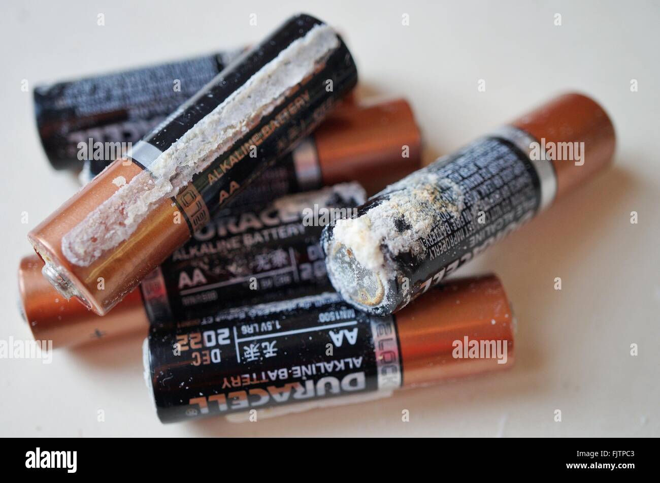 Old alkaline household batteries leak a white crusty substance made of  potassium carbonate (K2CO3 Stock Photo - Alamy