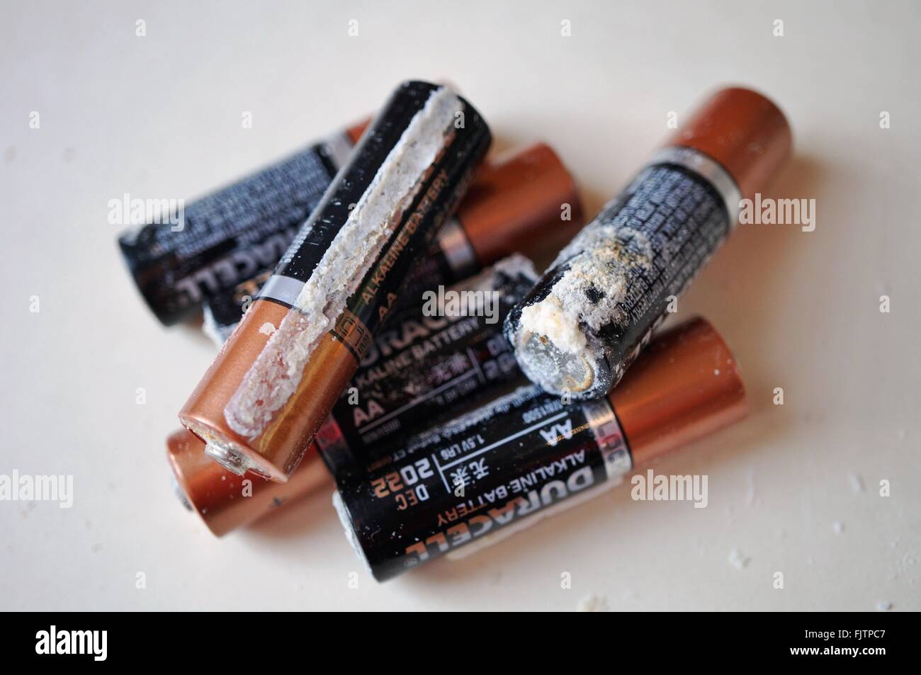 Old alkaline household batteries leak a white crusty substance made of  potassium carbonate (K2CO3 Stock Photo - Alamy