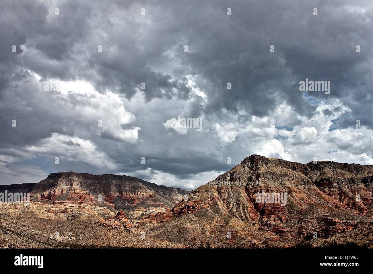 Scenic View Of Mountains Against Cloudy Sky Stock Photo
