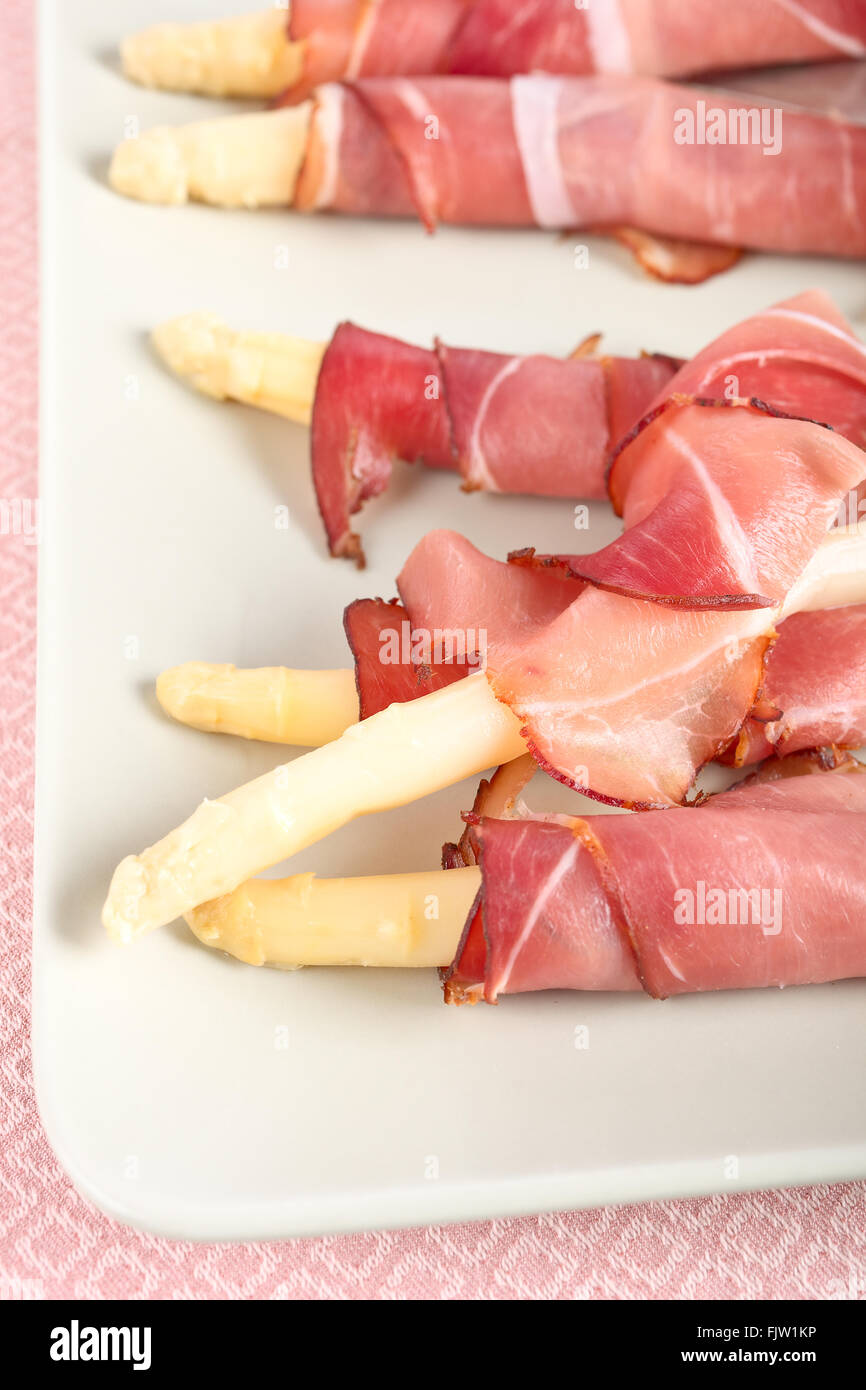 White asparagus wrapped in a Parma ham Stock Photo Alamy