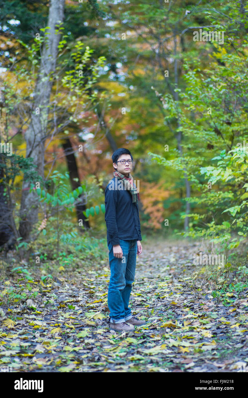 Full Length Portrait Of Man Standing In Forest Stock Photo - Alamy