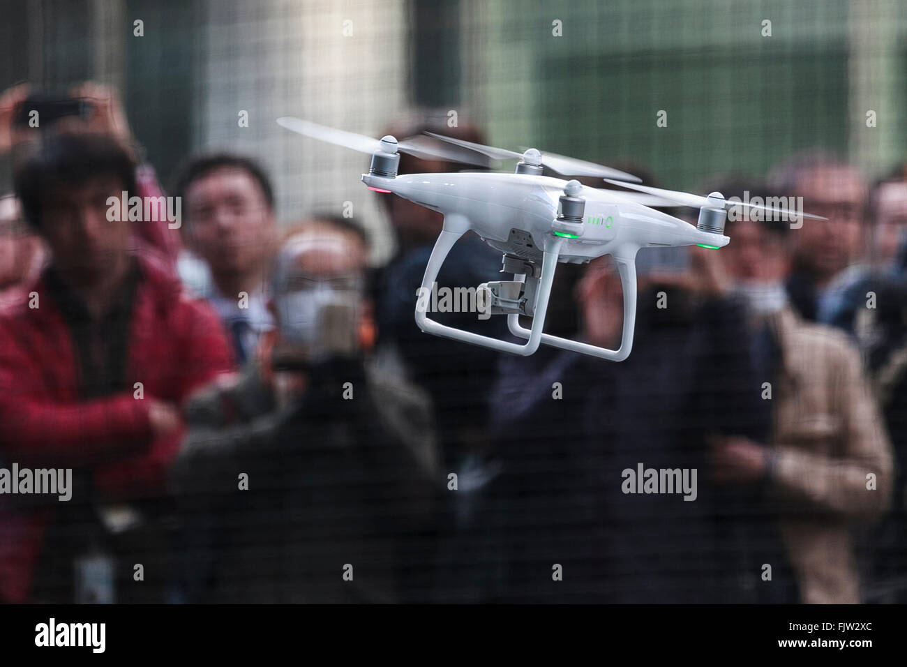 Tokyo, Japan. 3rd March, 2016. The new generation Phantom 4 that can dodge obstacles and track performs during a media event in Roppongi Hills on March 3, 2016, Tokyo, Japan. DJI's new model integrates a set of stereo cameras and proximity sensors that work with a computer software vision, which allows the Phantom 4 to fly autonomously. The new generation drone includes two newly added features, the ActiveTrack to continuously record a moving object and TapFly that allows users to select waypoints by controlling their smartphone or tablet. Credit:  Aflo Co. Ltd./Alamy Live News Stock Photo