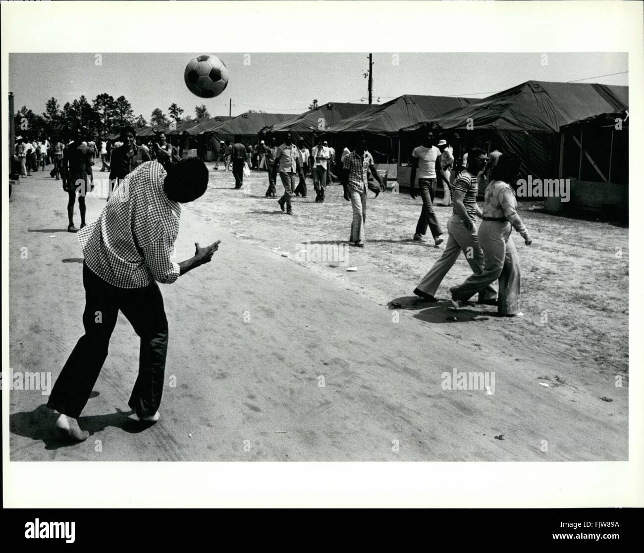 1980 - Cuban refugee pass the time by playing soccer in the tent city ...