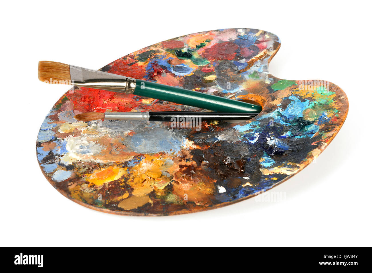 Artist palette with paintbrushes isolated over white background Stock Photo