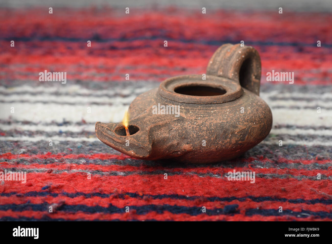 Ancient oil lamp from Israel over colorful textile Stock Photo Alamy