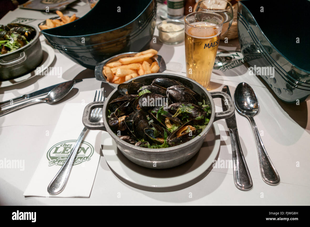 Moules marinières et frites; mussels with fries, served at Chez Léon restaurant in Brussels, Belgium. Stock Photo