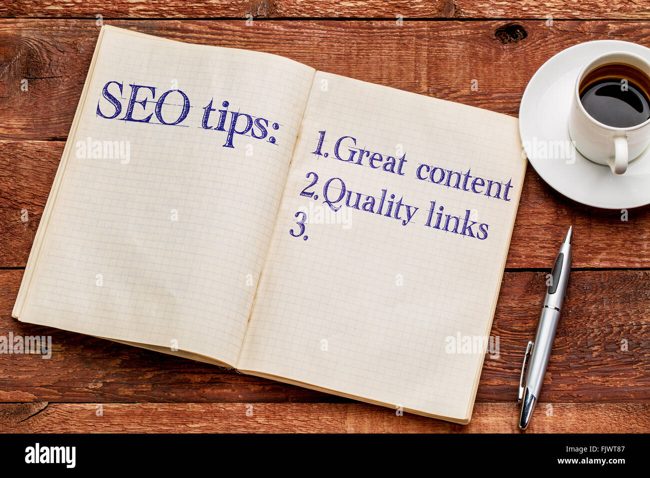 SEO (search engine optimization) tips (great content and quality links) in an old notebook with a cup of coffee Stock Photo