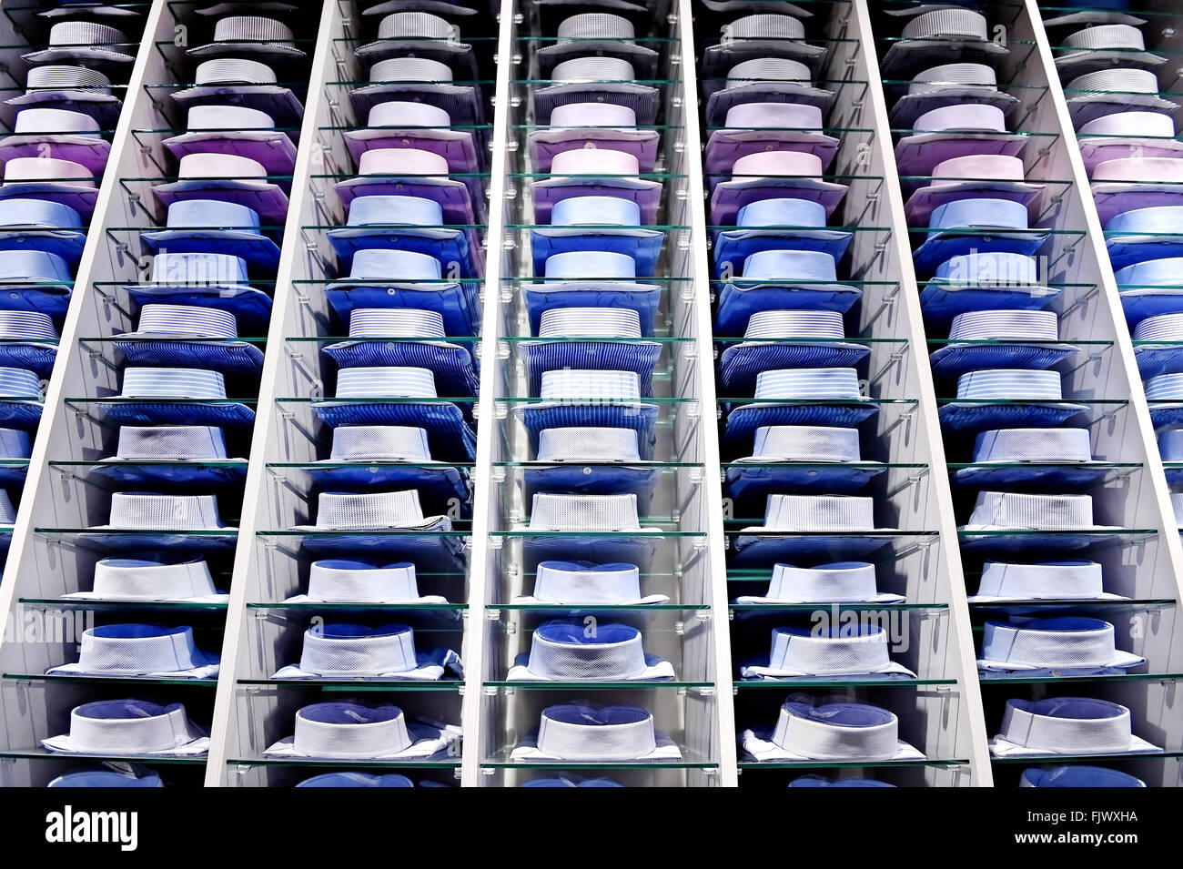 Lots of elegant shirts packed on shelves in a store Stock Photo