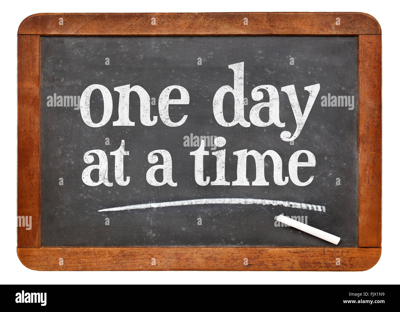 One day at a time  - white chalk text on a vintage slate blackboard Stock Photo