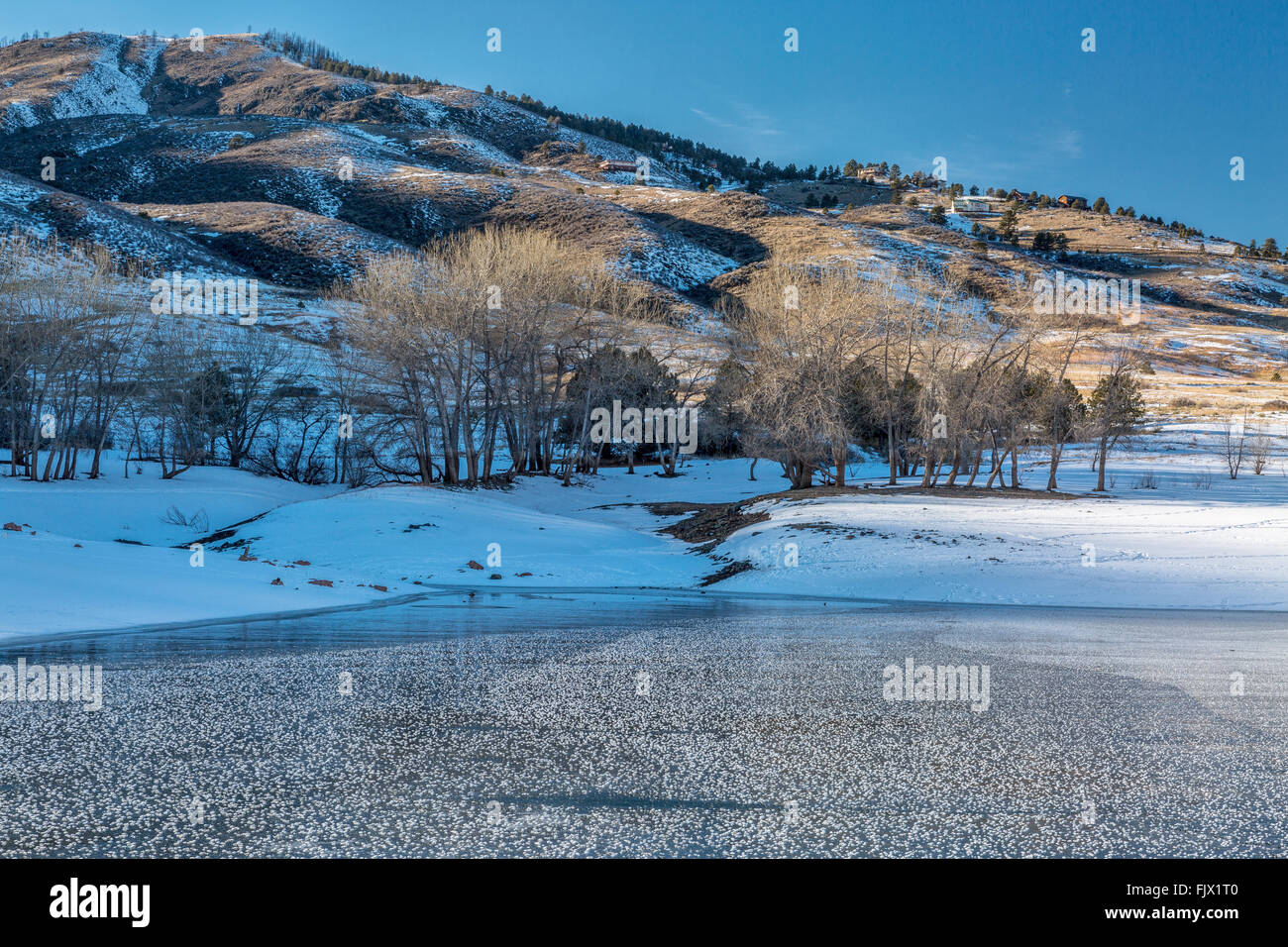 frozen Horsetooth Reservoir and Lory State Park at winter sunset, Fort COllins, COlorado Stock Photo
