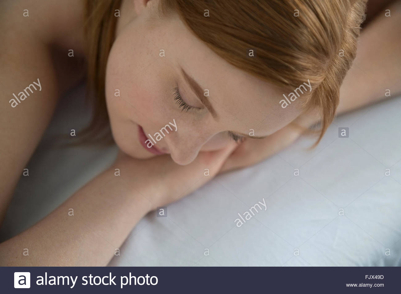 Serene woman laying massage table with eyes closed Stock Photo
