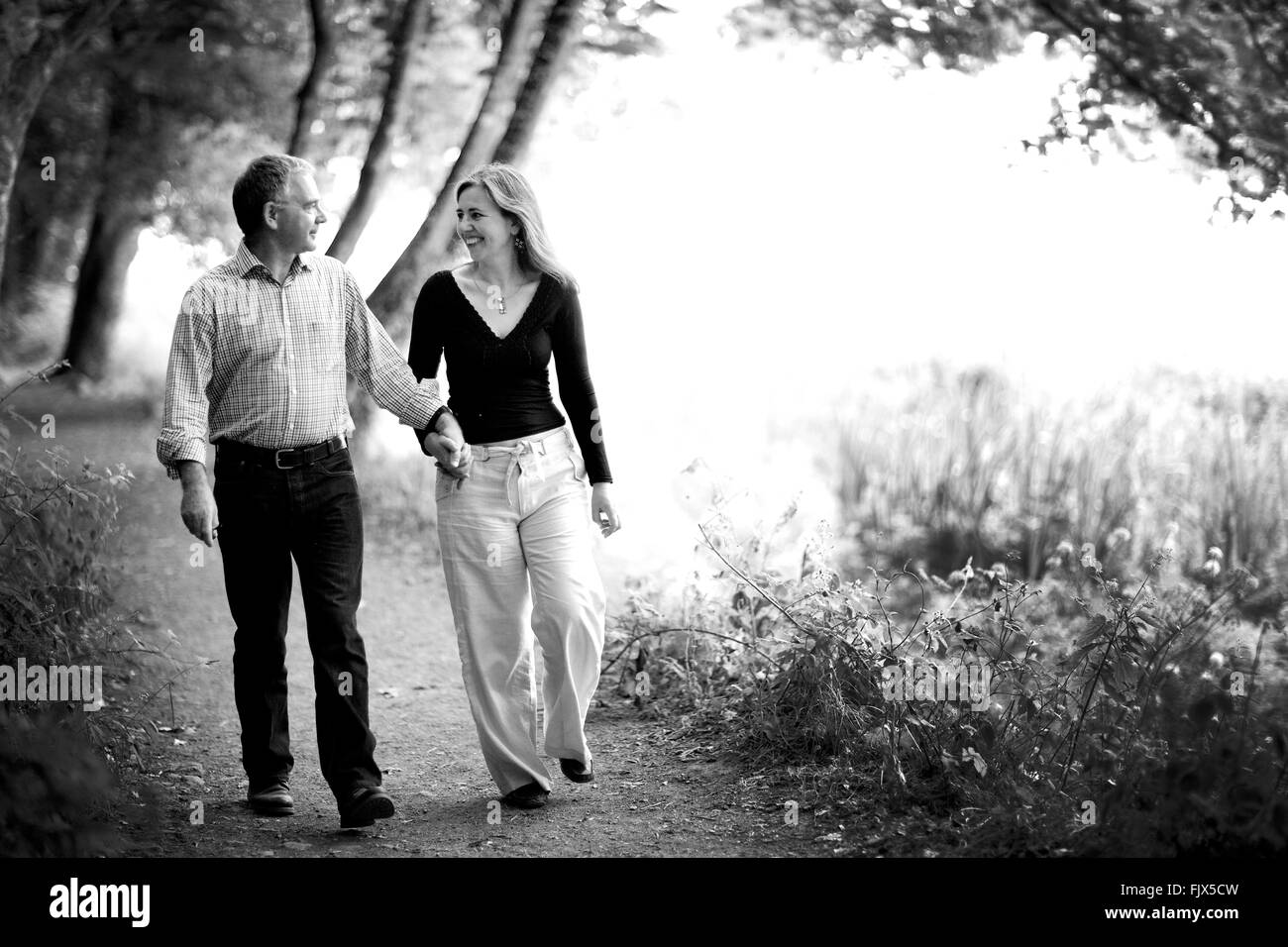 Middle aged couple walking in the woods Black and White Stock Photos ...