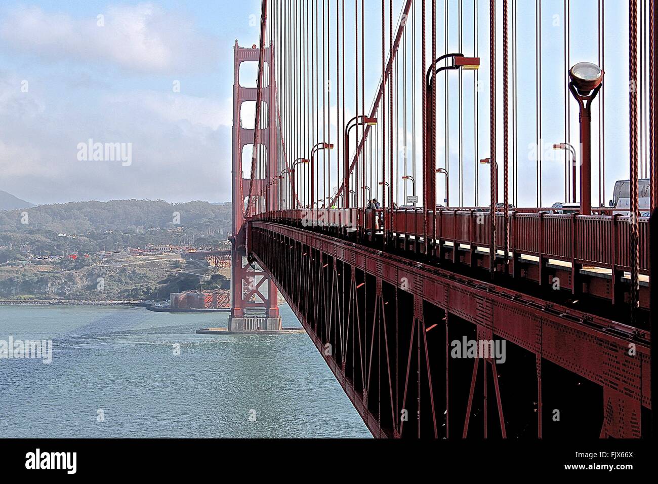 Golden Gate Bridge On Bay Of Water Against Sky Stock Photo