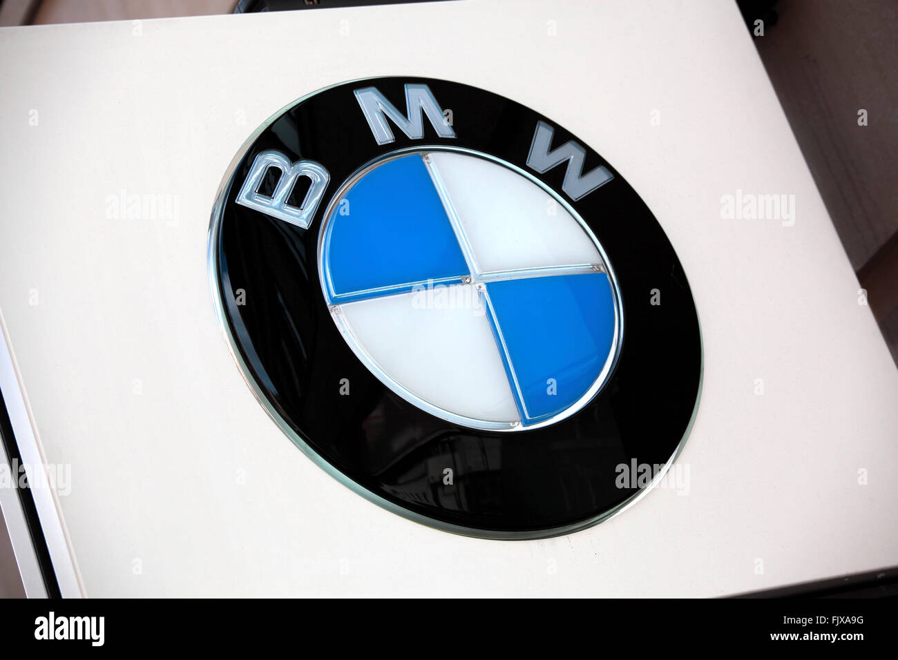 Illuminated BMW advertising sign above the entrance to a BMW car dealer showroom in Knightsbridge London. Stock Photo
