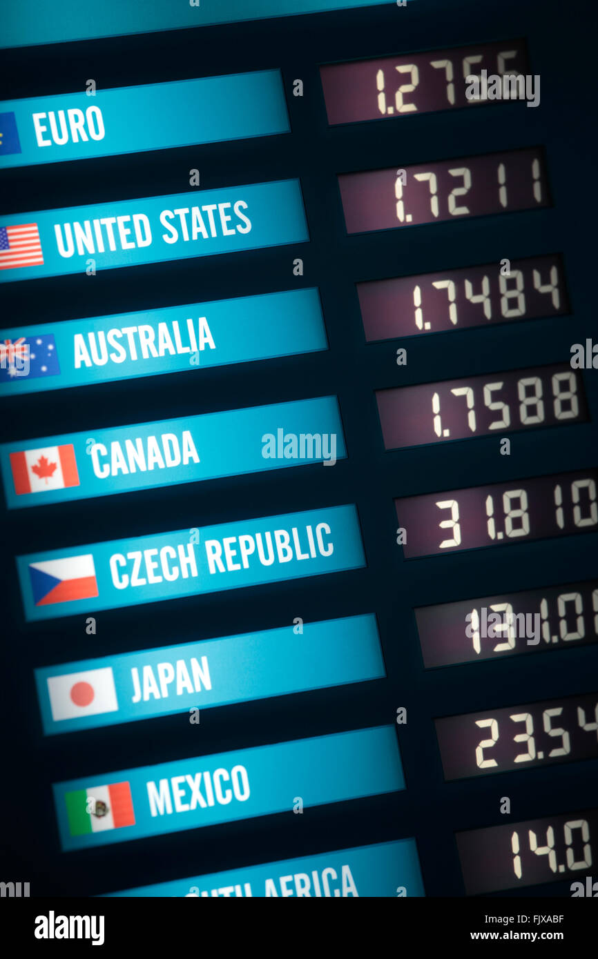 Illuminated currency exchange board showing exchange rates for various countries and currencies. Stock Photo