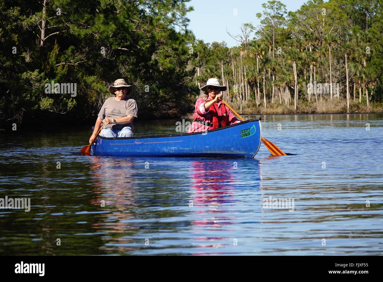 Couple paddling a canoe on Strickland Creek, Florida Stock Photo