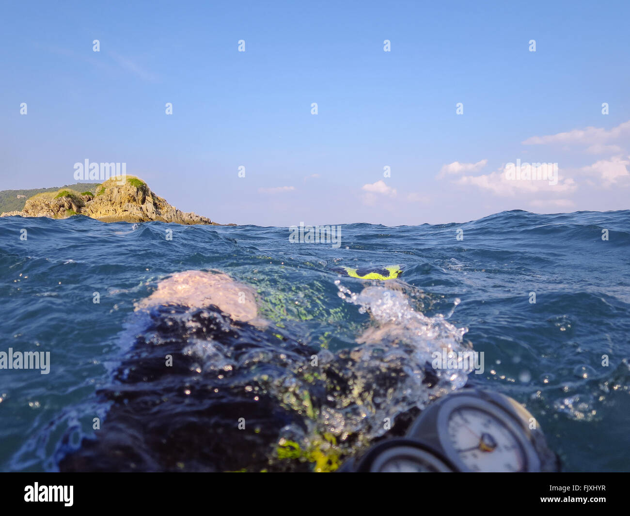 Person Scuba Diving At Sea Against Sky Stock Photo