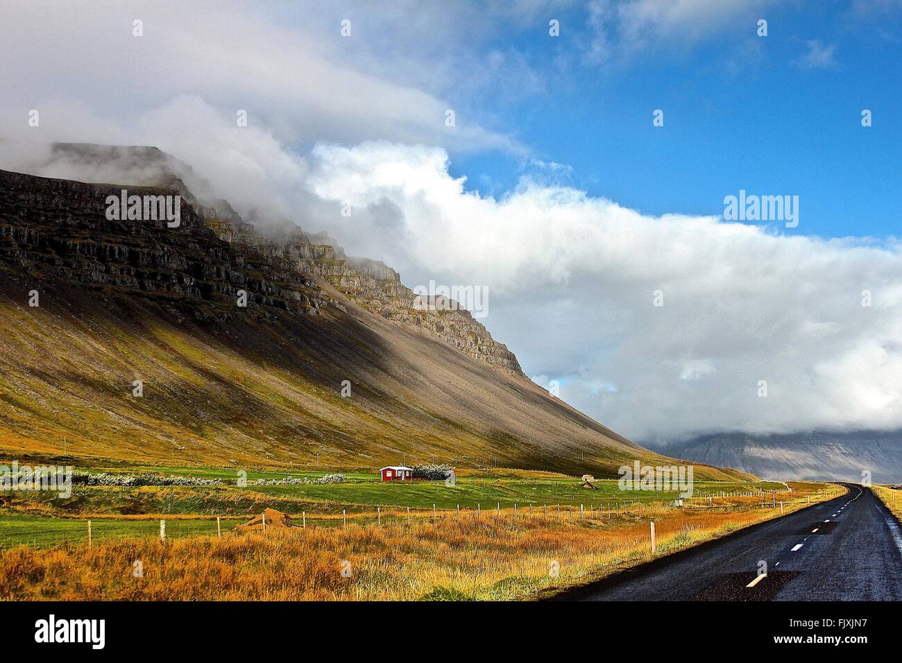 Idyllic View Of Mountain Against Cloudy Sky Stock Photo