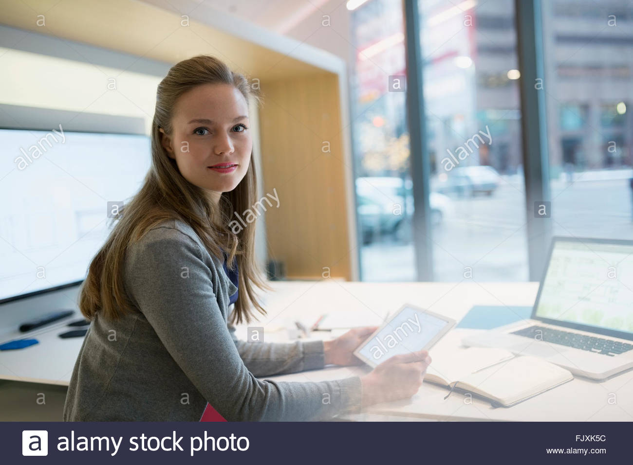 Portrait confident young businesswoman with digital tablet Stock Photo