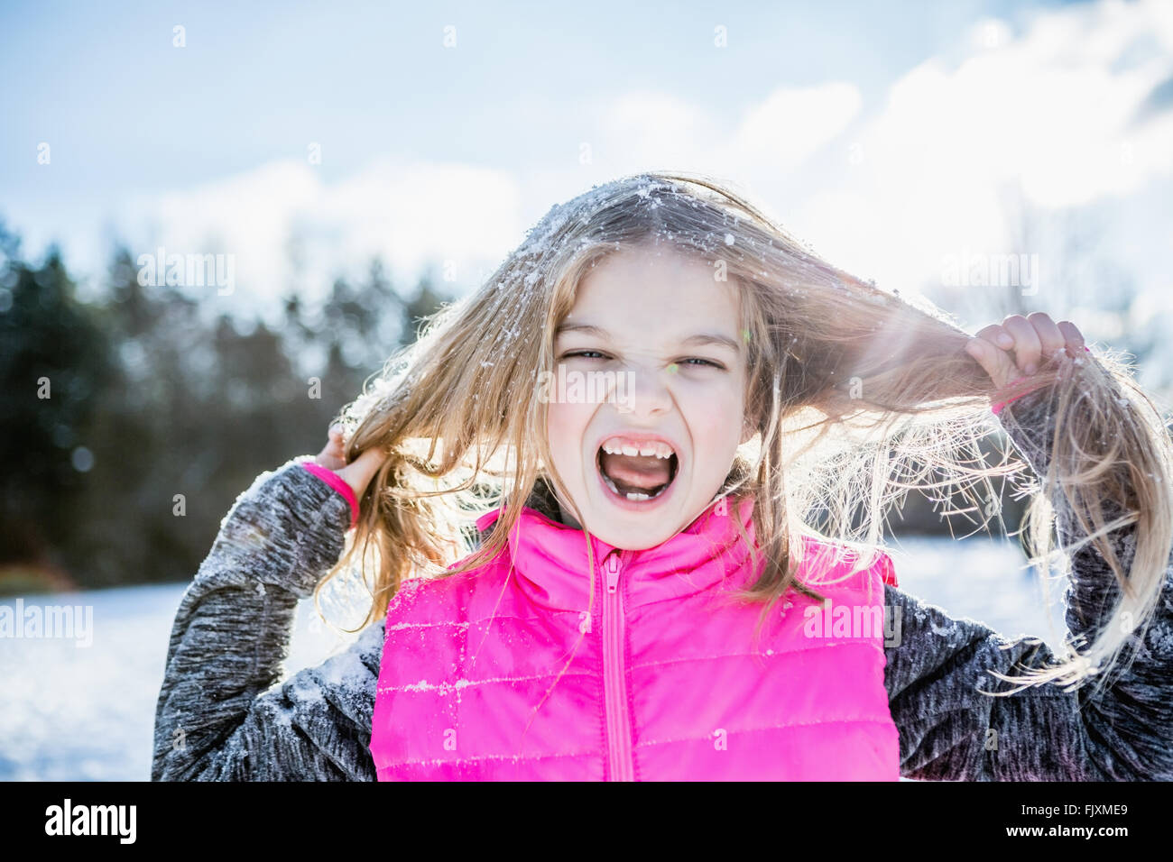 Little girl screaming while holding her hair Stock Photo