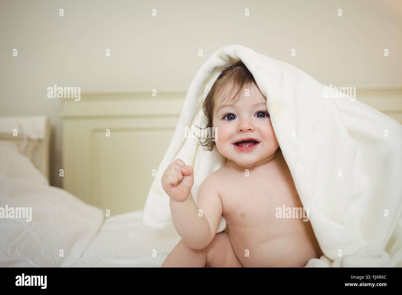Cute baby hiding under a blanket Stock Photo Alamy