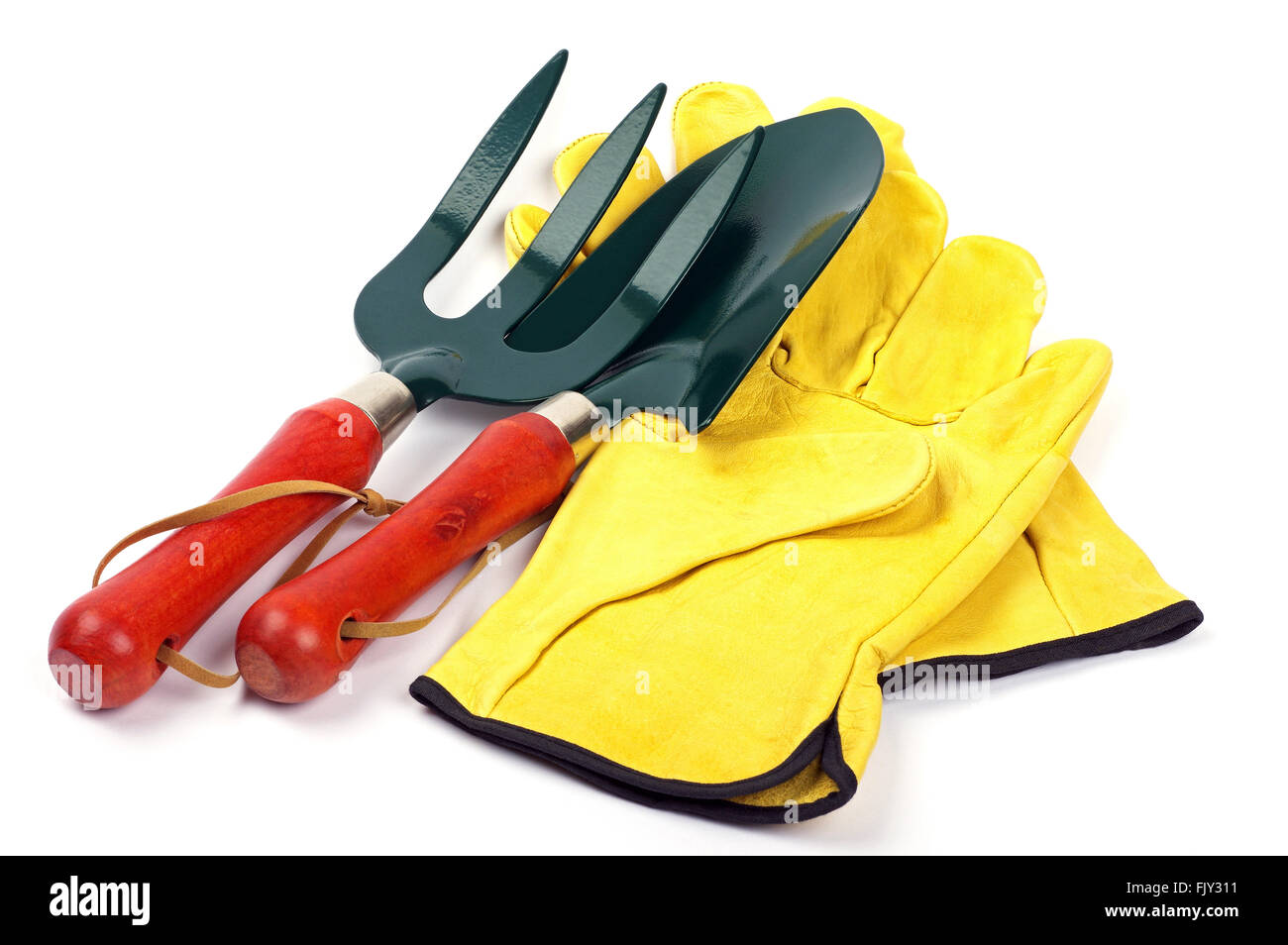 garden trowel and fork with leather gardening gloves side by side on a white background Stock Photo