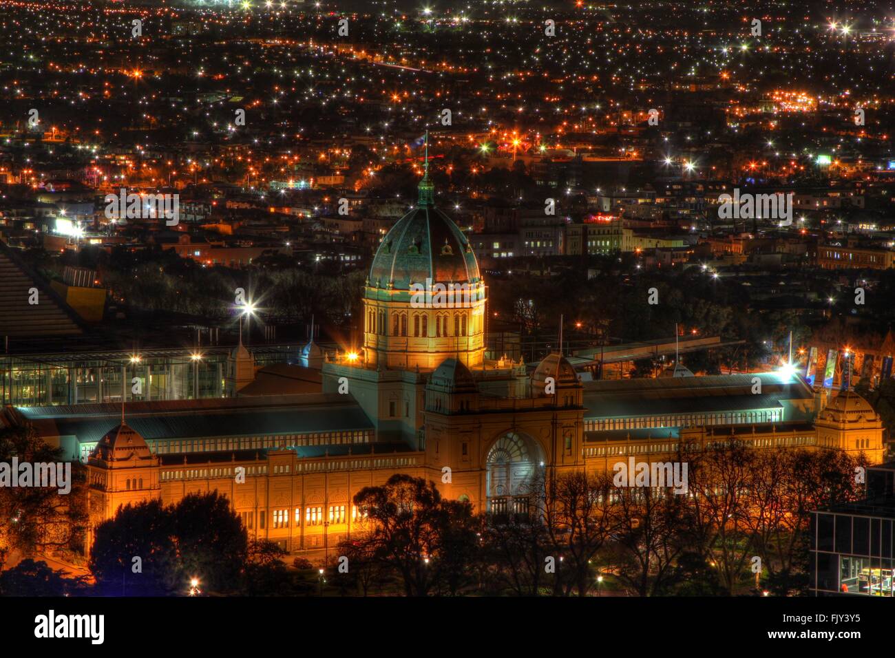 Illuminated Royal Exhibition Building And Cityscape At Night Stock Photo
