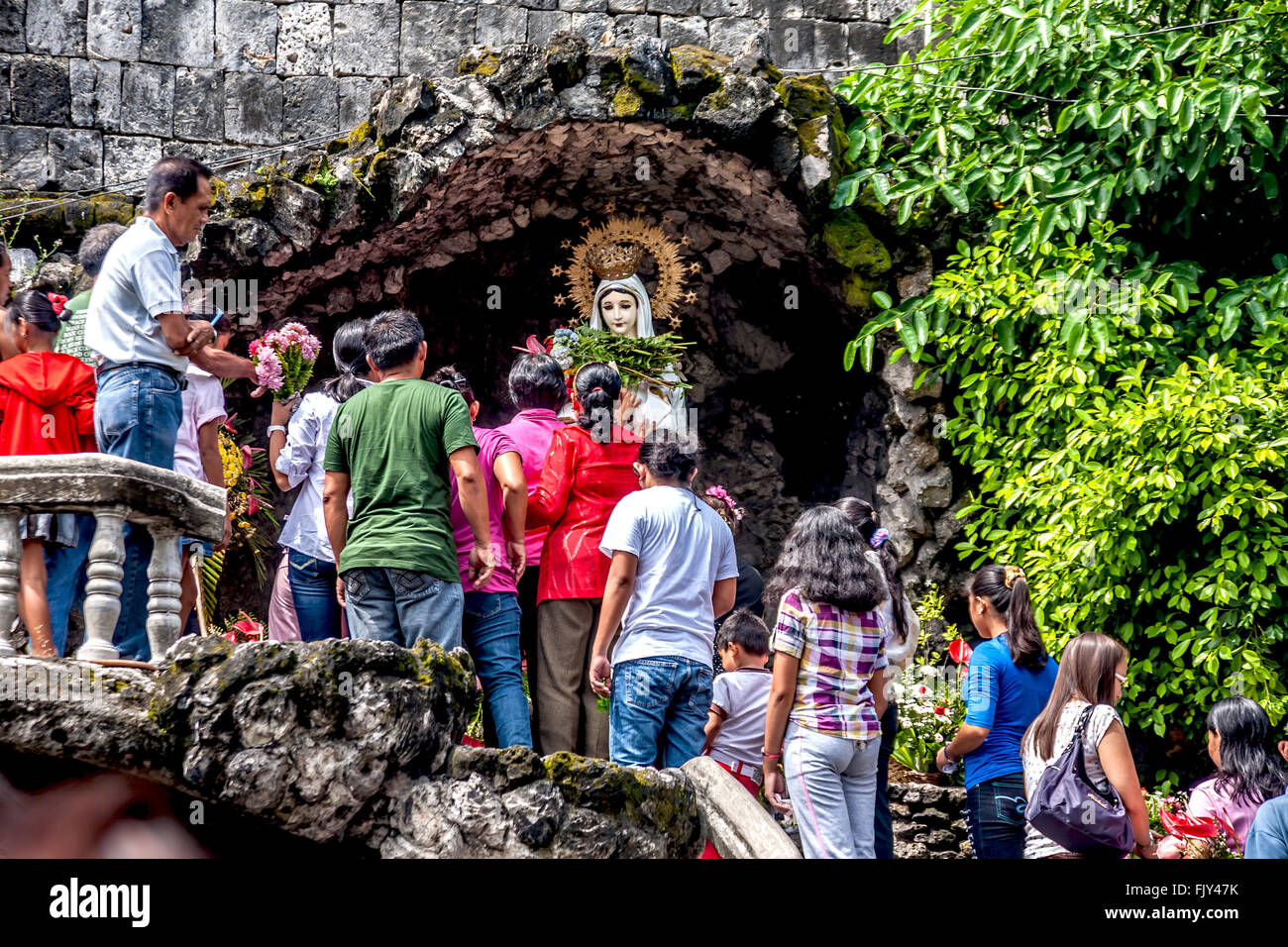 Philippines Negros Dumaguete Worshippers at the shrine outside Dumaguete cathedral  Adrian Baker Stock Photo
