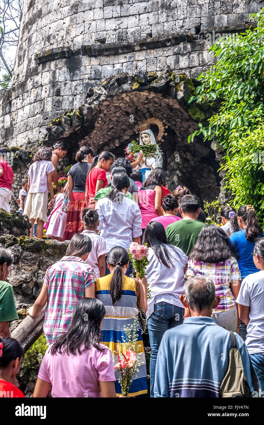 Philippines Negros Dumaguete Worshippers at the shrine outside Dumaguete cathedral  Adrian Baker Stock Photo