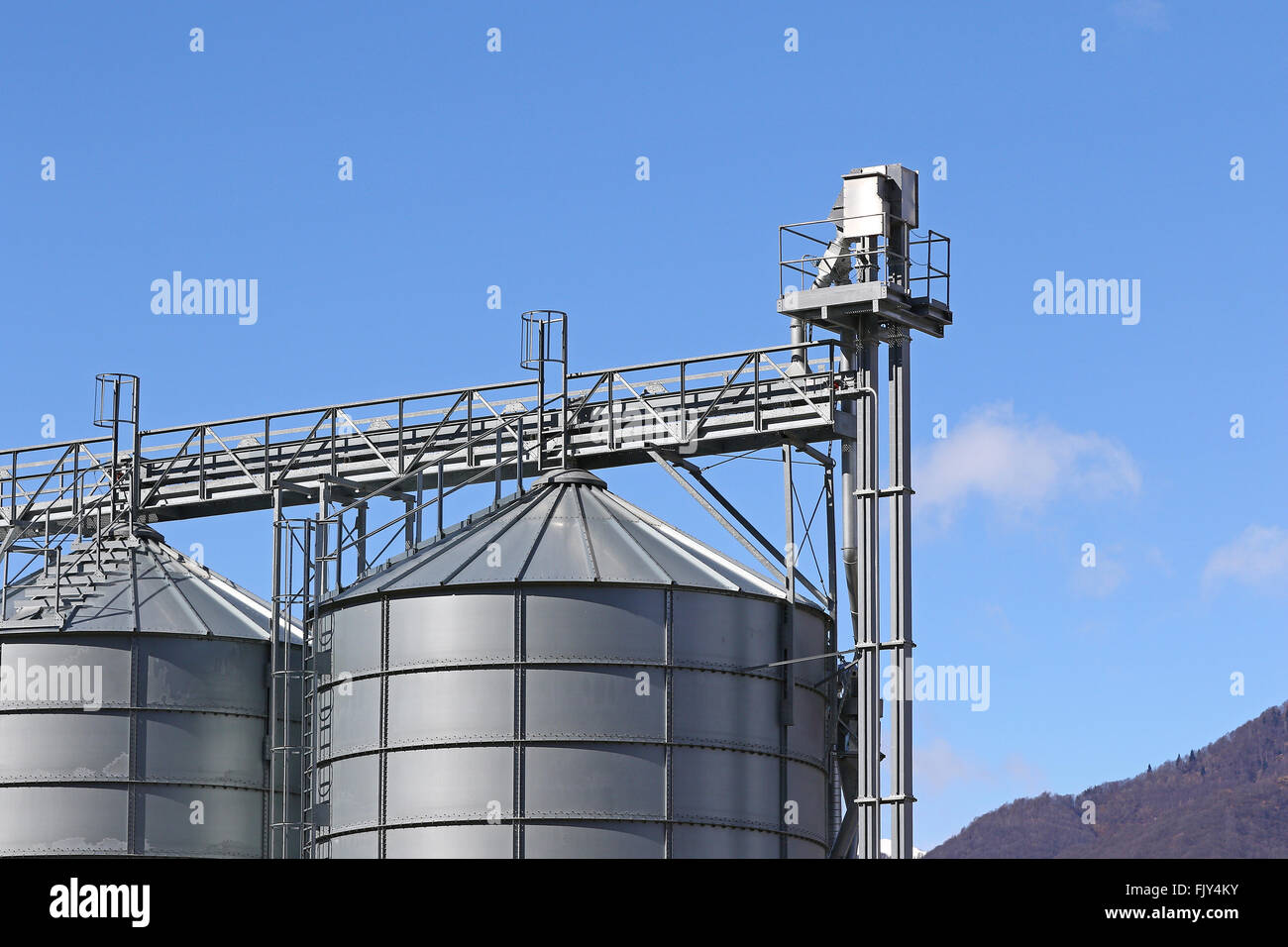 Top of agricultural storage silos against blue skies Stock Photo