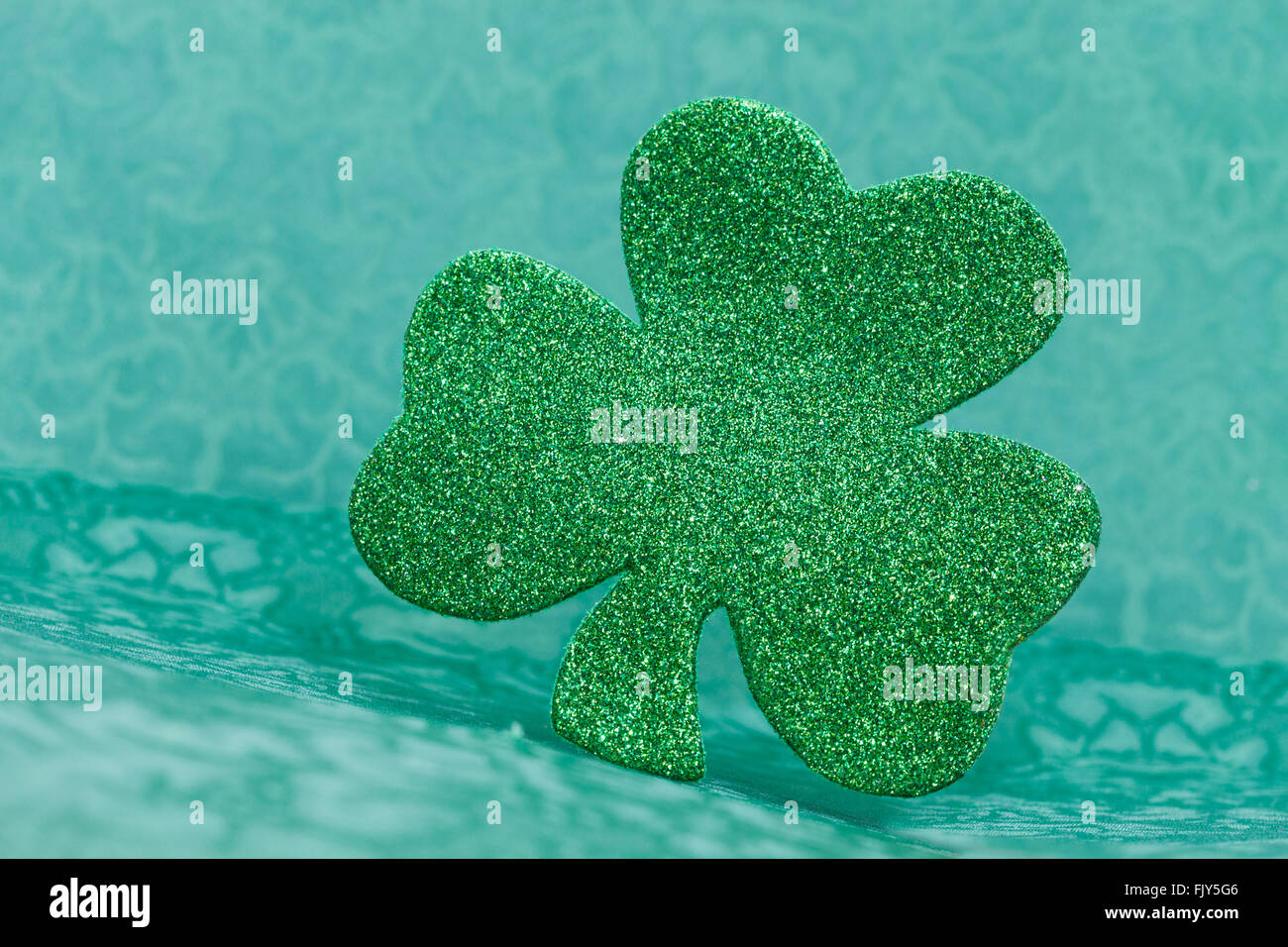 Glitter shamrock on greeen fabric background Stock Photo Alamy