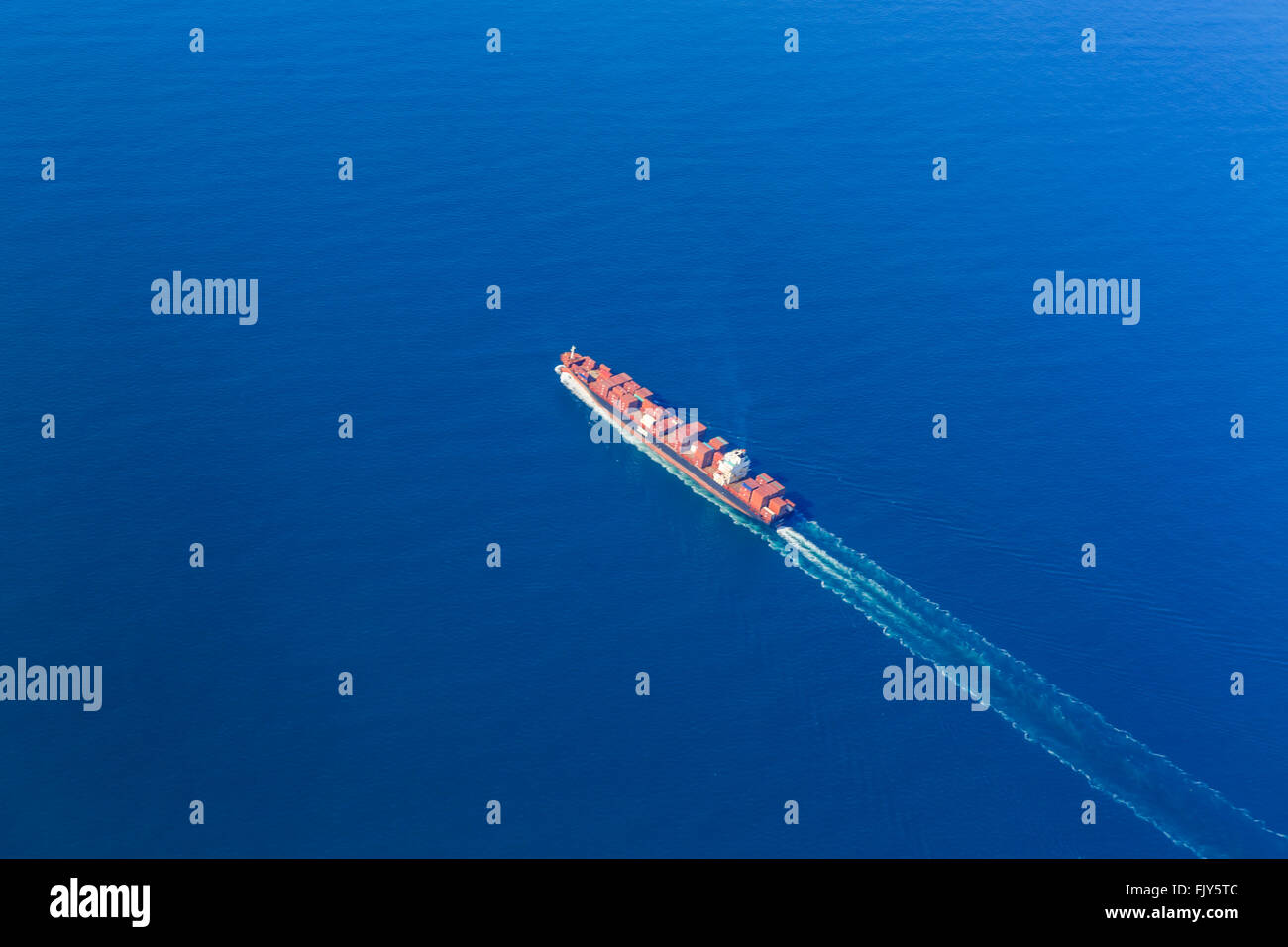 Aerial view of ship carrying freight to the port of New York in a bright blue ocean Stock Photo