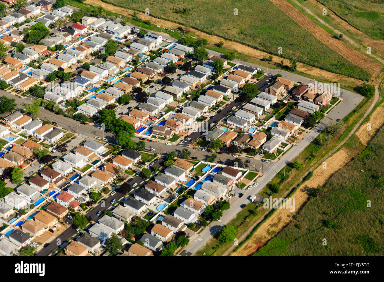 Aerial view at sunrise of suburban housing in neighborhood on long island on approach to New York city airport Stock Photo