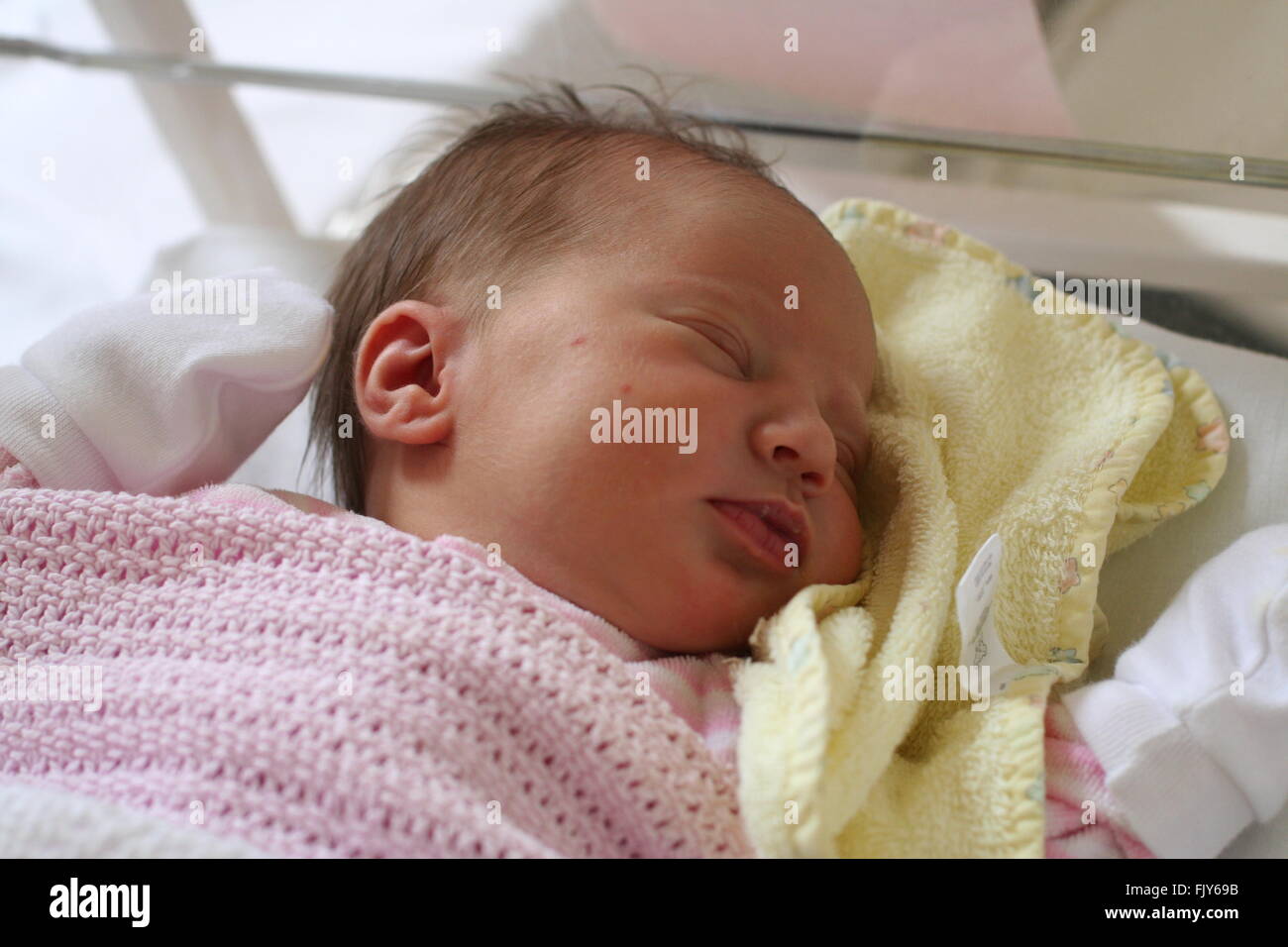 Baby girl wrapped top in pink blanket