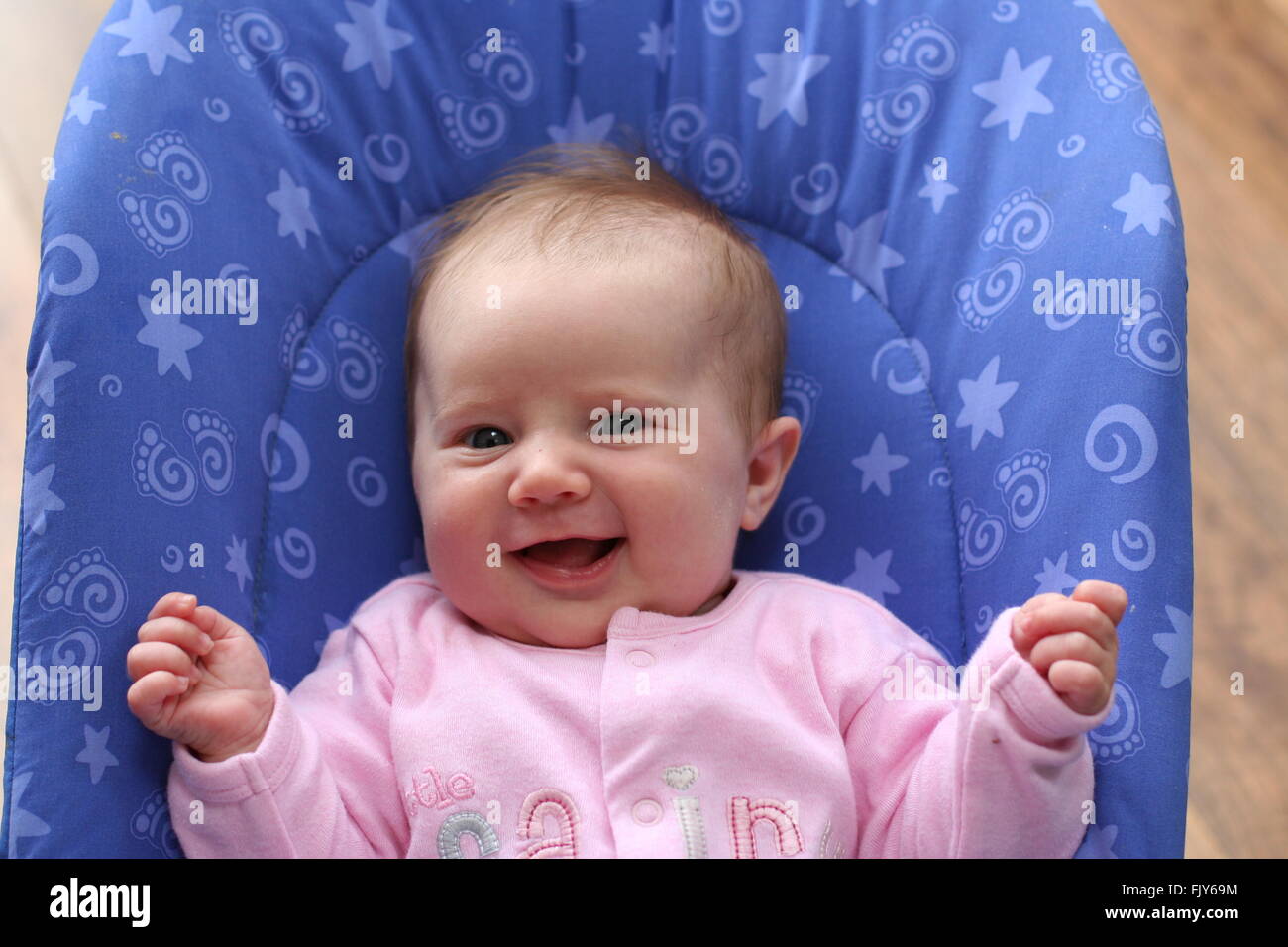 little baby girl wearing pink laughing out loud Stock Photo Alamy