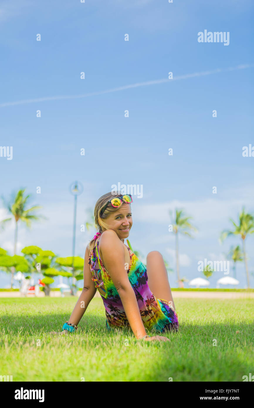 Outdoor portrait of young woman lying on the grass Stock Photo - Alamy