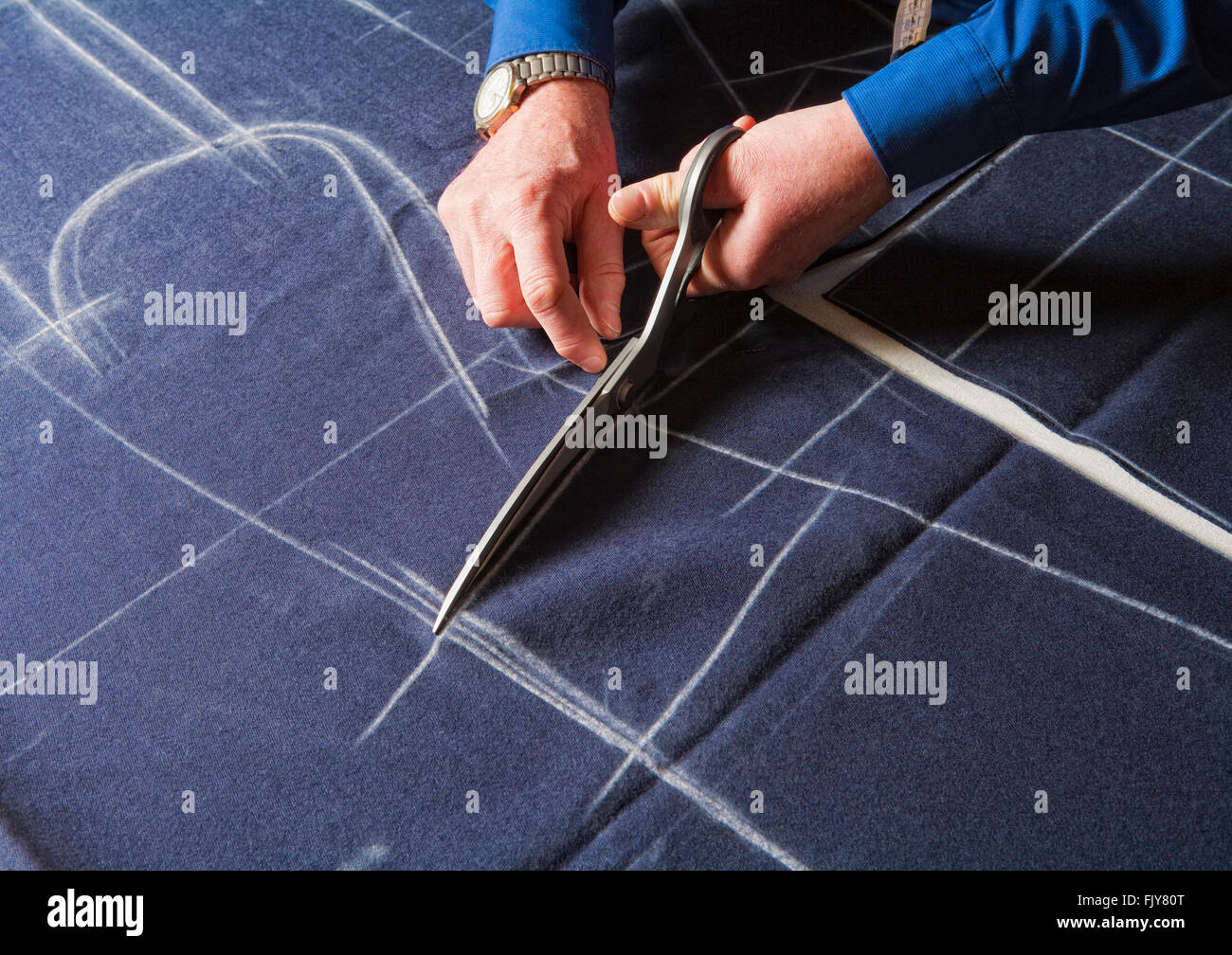 Tailor Cutting Fabric to a New Coat with Scissors Stock Photo Alamy