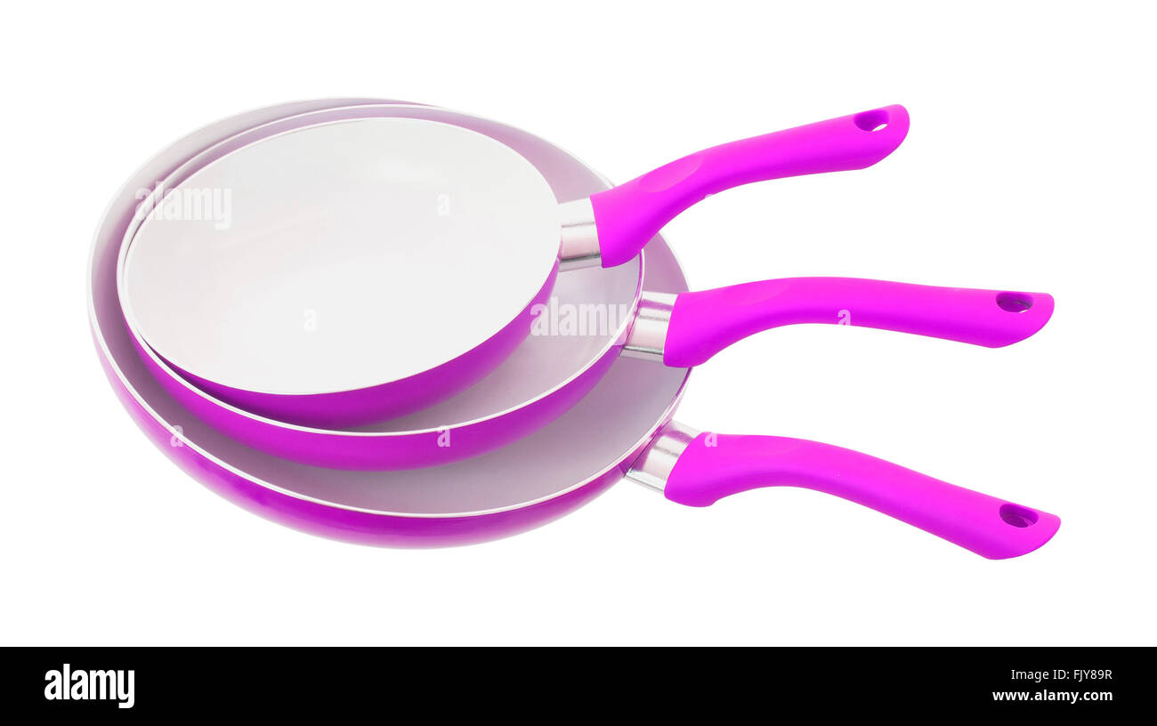 Set of three frying pans, isolated, close-up, pink Stock Photo
