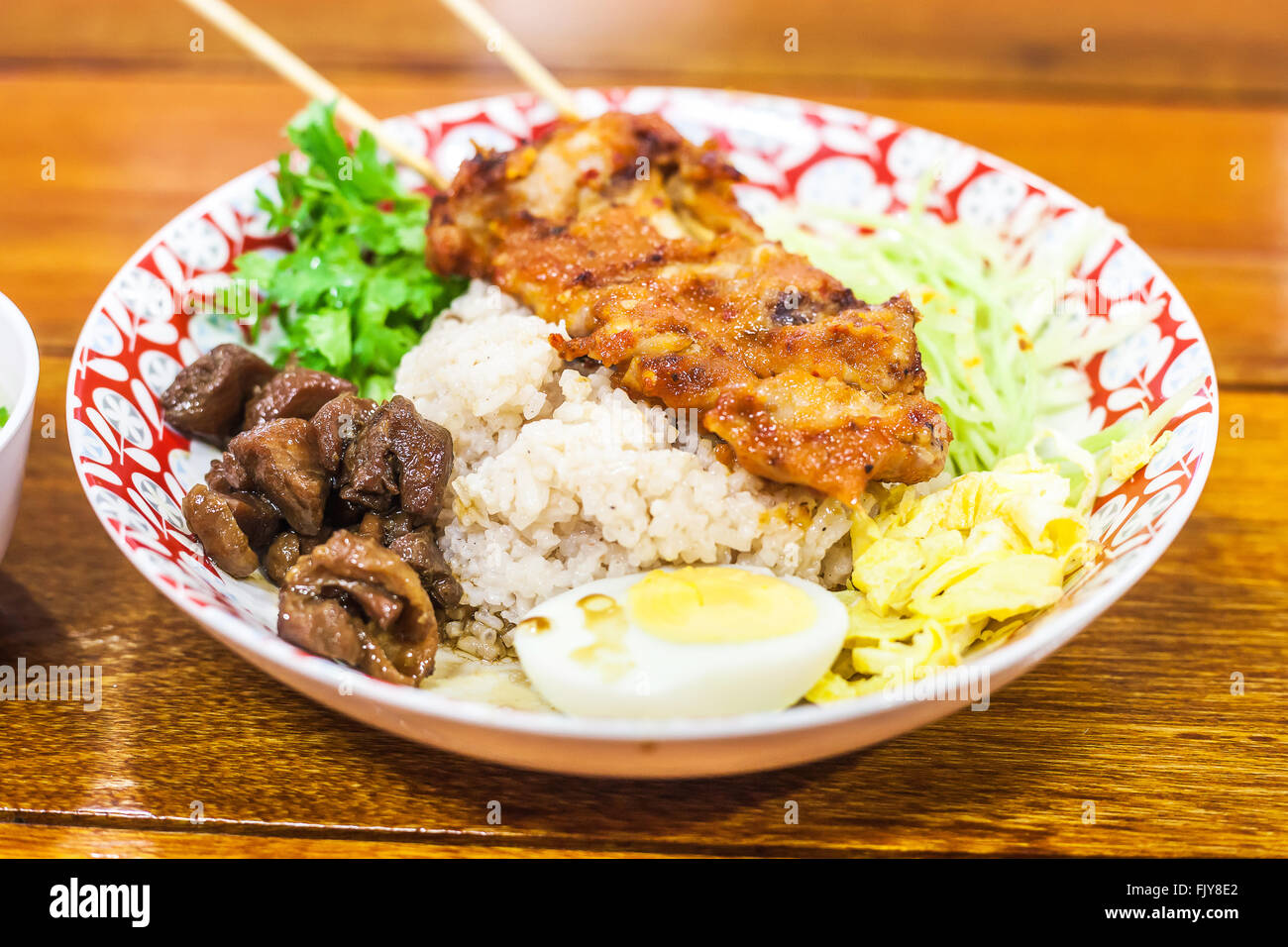 Rice Mixed with Shrimp paste and chicken grill In restaurant Stock Photo