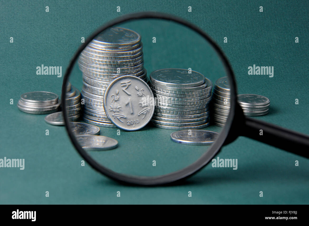 Magnifier and coins Stock Photo