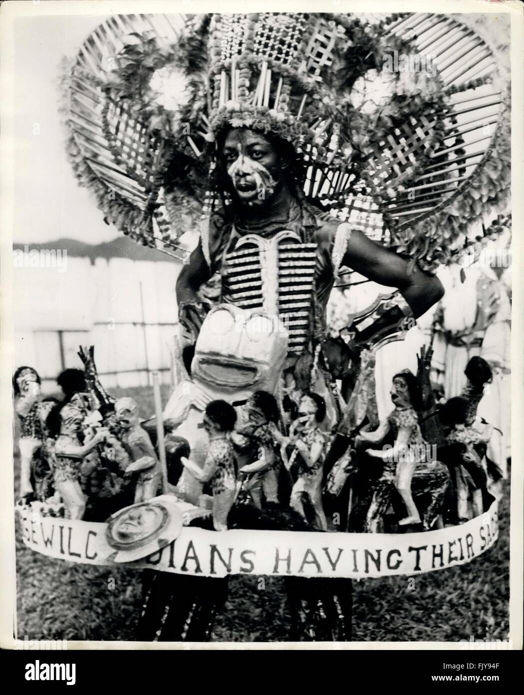 1952 - It is Carnival Time in the British West Indies. A Gay Time Is Had By All. Carnival time in the British West Indies is a gay time - may pole dancer for the children old time English style dances mixed with the native versions. Girl dancers can be seen on the golden sanda performing their own dances - a mixture of European and African styles. The picturesque vendors of coconut milk, which they carry on their heads in converted oil drums, do a roaring trade - and when the milk is laced with local rum - then things really do begin to hum - happily. Photo shows The ''wild Indian'' with his s Stock Photo