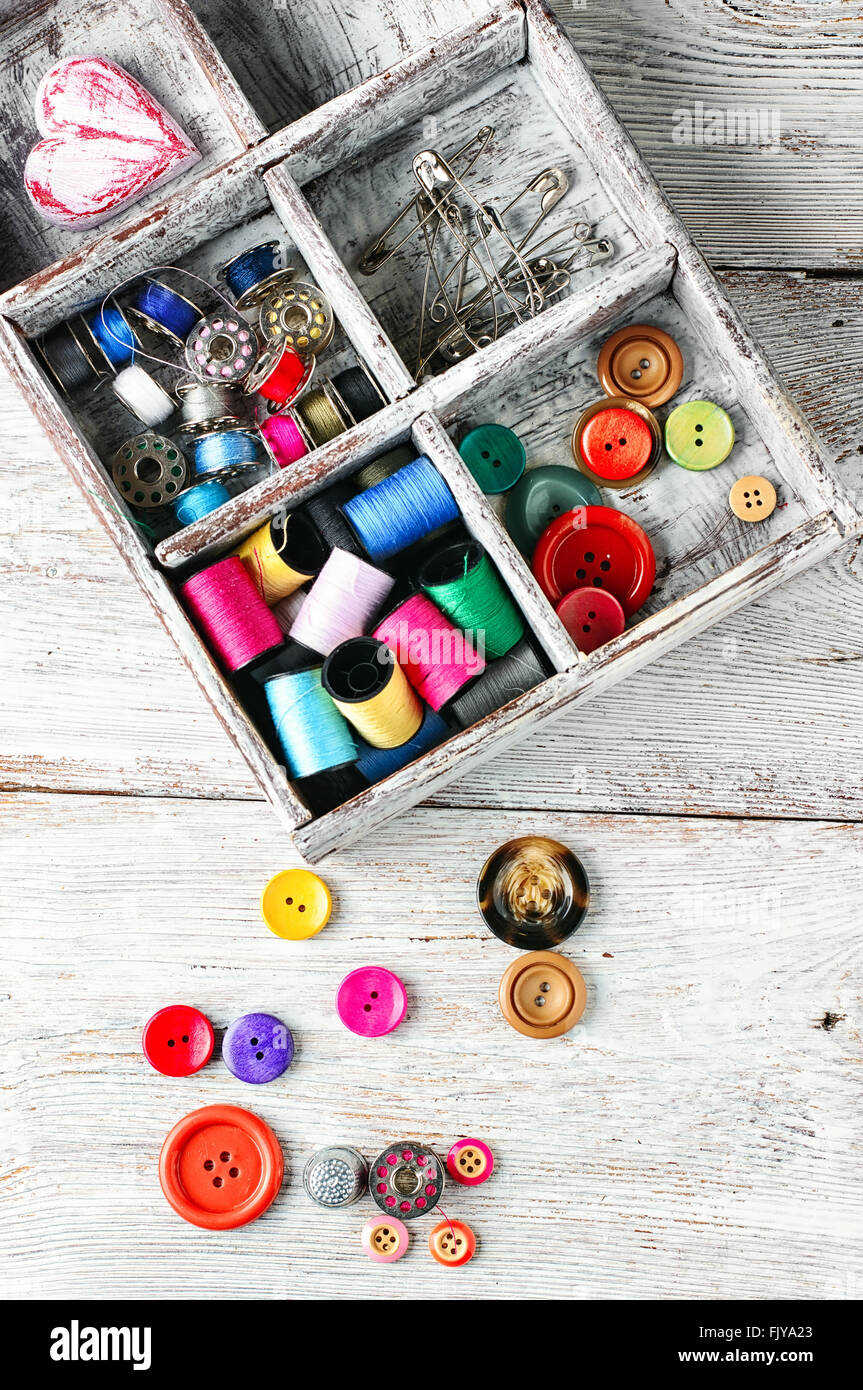 Light wood box with threads,buttons and pins.Top view Stock Photo