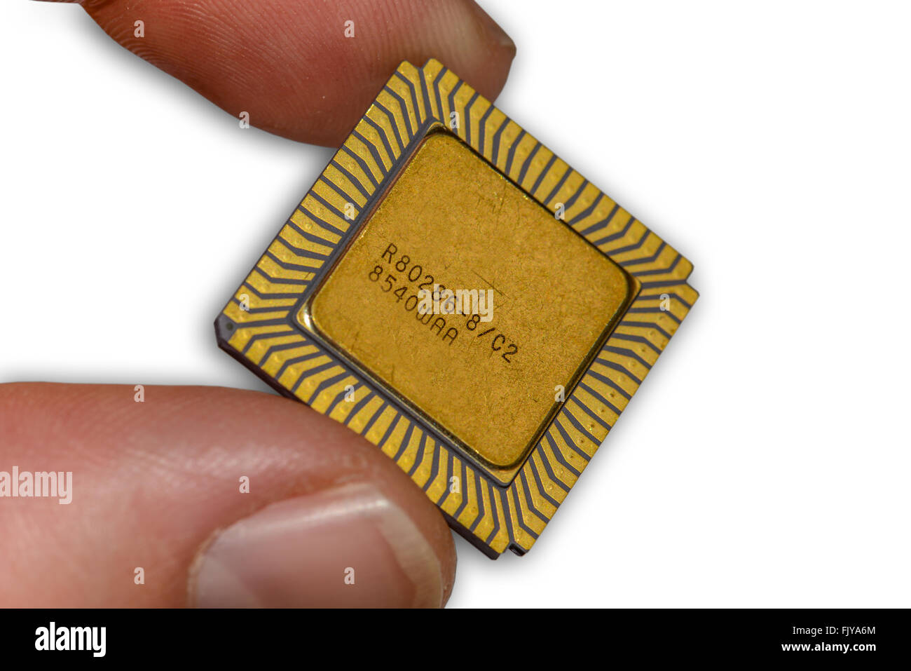 One vintage ceramic CPU between two fingers Stock Photo