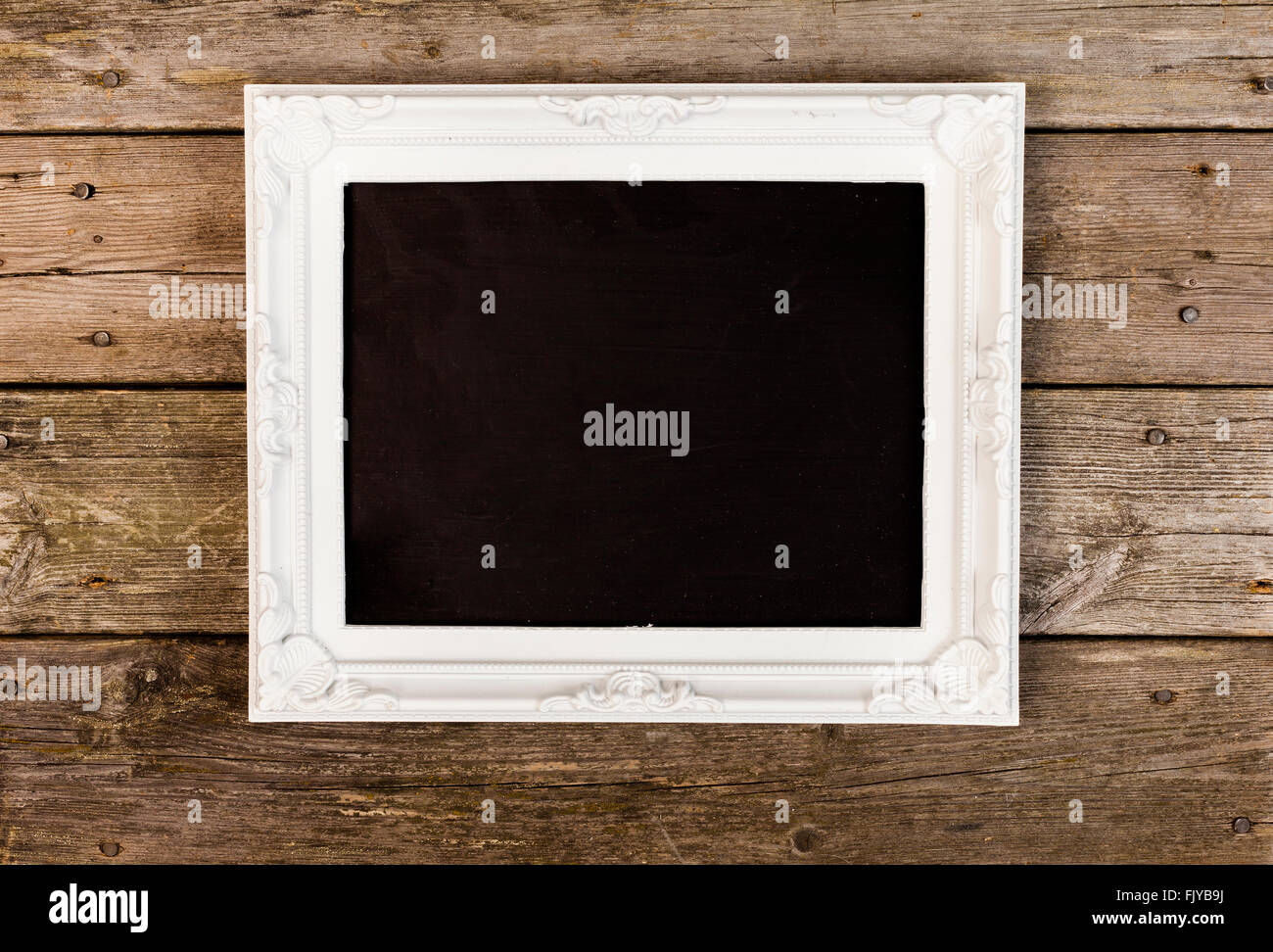 white antique empty picture frame on wooden background Stock Photo - Alamy