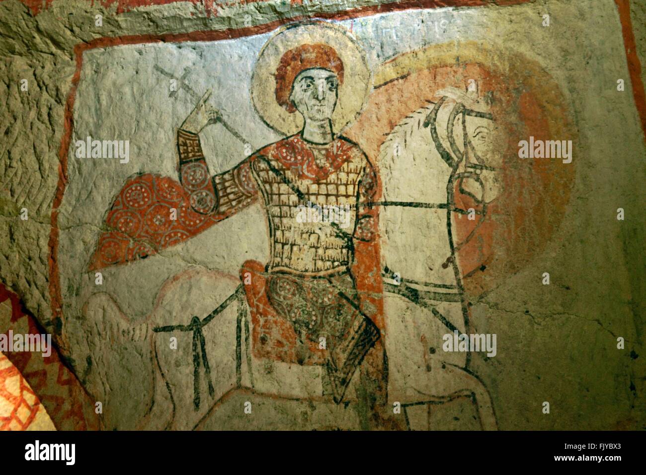 Early Christian mural. Saint George slaying dragon in rock carved Saint Basils Church. Goreme National Park, Cappadocia Turkey Stock Photo