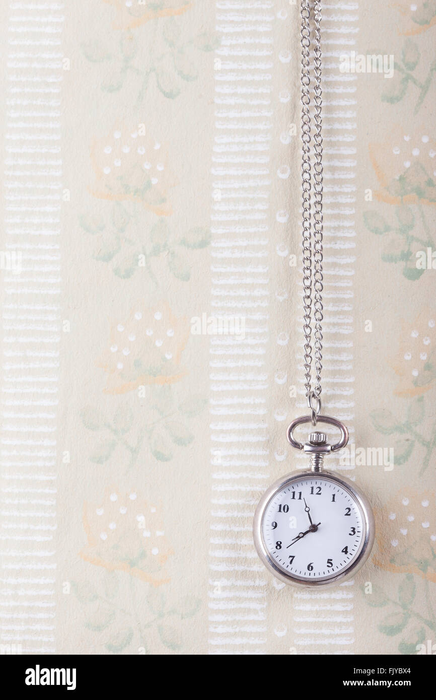 old pocket watch on the vintage wallpaper background Stock Photo - Alamy